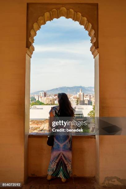 woman looks at view at alcazaba in malaga andalusia spain - alcazaba of málaga stock pictures, royalty-free photos & images