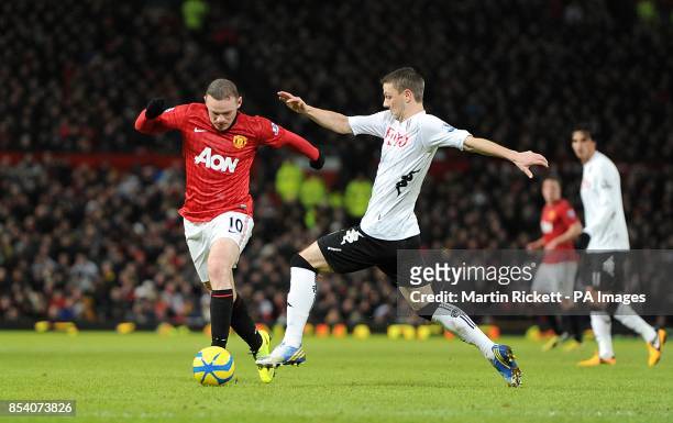 Manchester United's Wayne Rooney and Fulham's Chris Baird battle for the ball