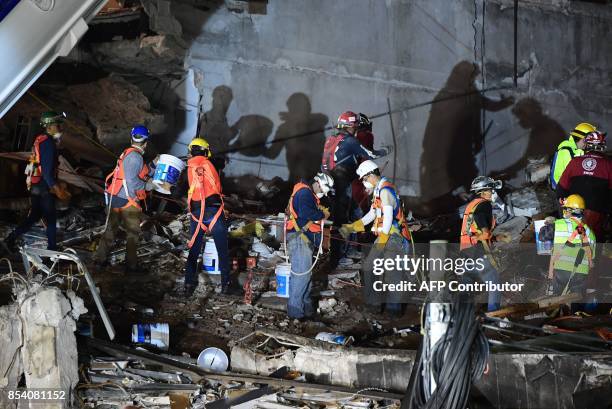 Rescuers keep searching for survivors in a building toppled by a magnitude 7.1 quake that struck central Mexico a week ago, in Mexico City, on...