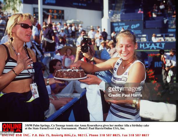 Palm Springs, Ca Teenage tennis star Anna Kournikova givers her mother Alla a birthday cake at the State Farm/Evert Cup Tournament.