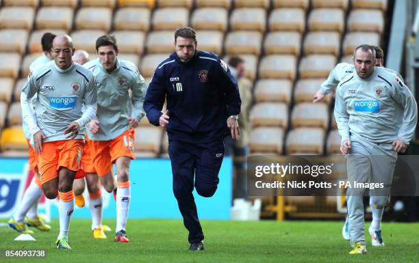 Blackpool first team coach John Murphy leads the warm-up