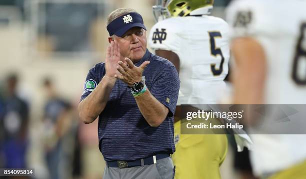 Notre Dame Fighting Irish head coach Brian Kelly watches the pregame warms ups prior to the start of the game against the Michigan State Spartans at...