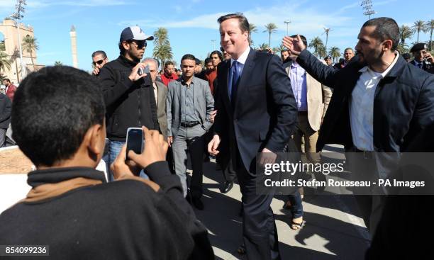 Prime Minister David Cameron takes a walk through Martyrs Square in Tripoli, Libya where he met local market traders and visitors.