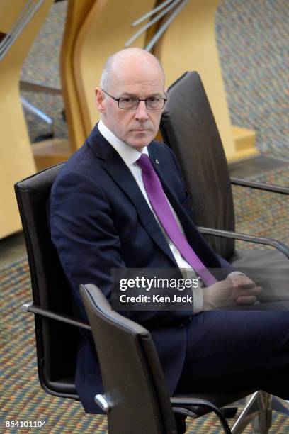 Scotland's Deputy First Minister John Swinney listens to opposition points after updating the Scottish Parliament on talks held in London this week...