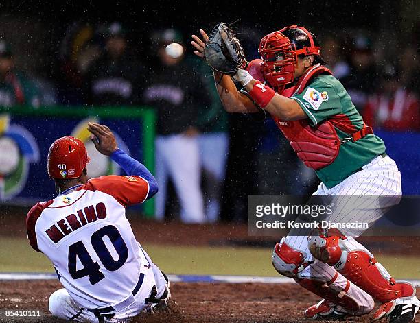 Rolando Marino of Cuba scores as catcher Miguel Ojeda of Mexico catches the late throw from left fielder Augustin Murillo during the 2009 World...