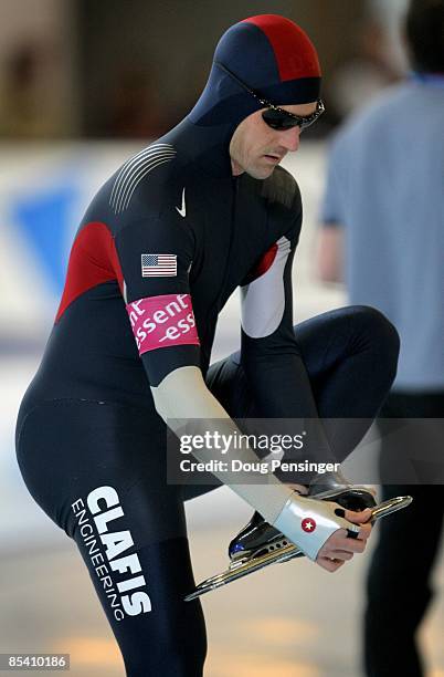 Chad Hedrick of the USA cleans his skate blade as he prepares to take the ice in the Men's 1500m at the ISU World Single Distance Speed Skating...