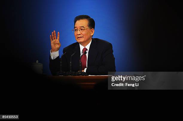 China's Premier Wen Jiabao gestures as he answers a question at a news conference at the Great Hall of the People after the closing session of the...