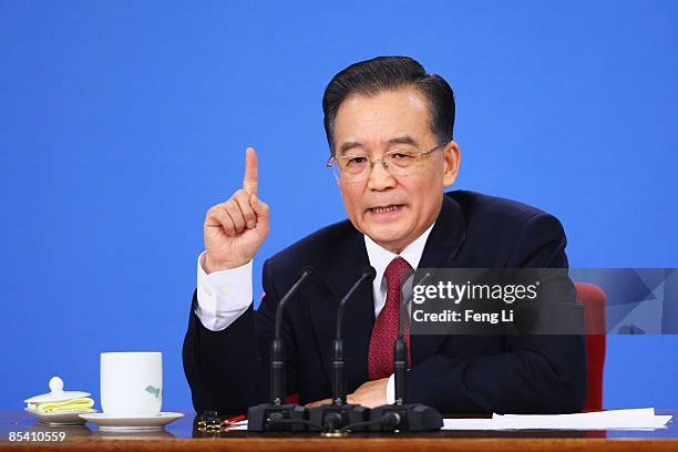 China's Premier Wen Jiabao gestures as he answers a question at a news conference at the Great Hall of the People after the closing session of the...