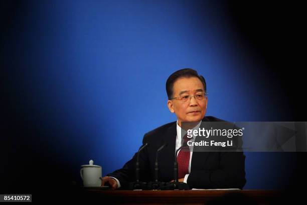 China's Premier Wen Jiabao answers a question at a news conference at the Great Hall of the People after the closing session of the National People's...