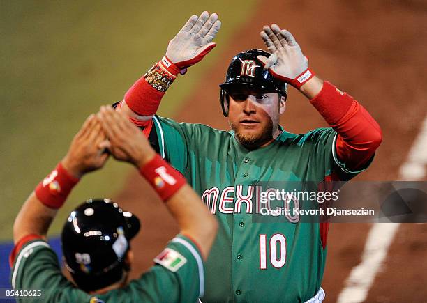 Karim Garcia of Mexico is congratulated after hitting a one-run home run against Cuba during the 2009 World Baseball Classic Pool B match on March...