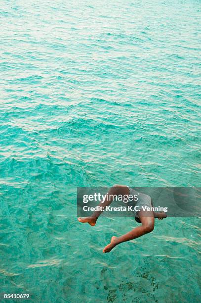 boy back diving into lake kivu, rwanda - lago kivu fotografías e imágenes de stock