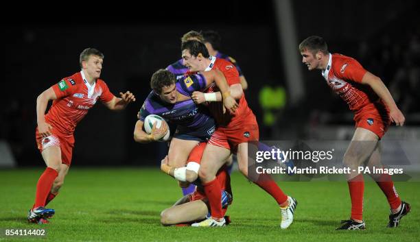 Wigan Warriors Sean O'Loughlin is tackled by Salford City Reds' Gareth Owen and Andrew Dixon during the Super League match at Salford City Stadium,...