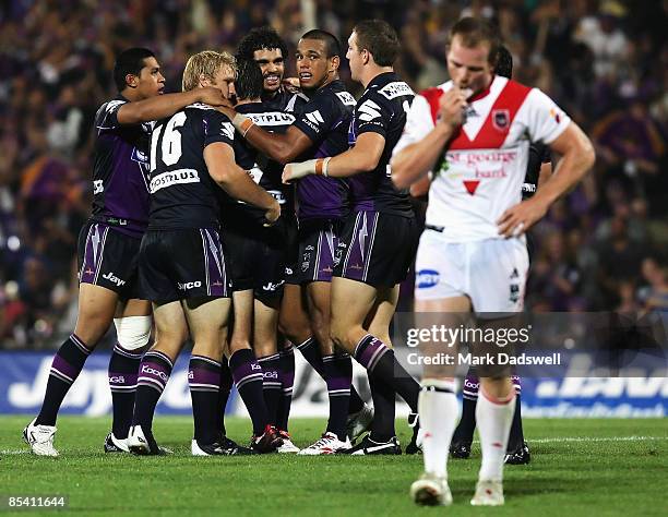 Greg Inglis of the Storm is congratulated by teammates after kicking the winning drop goal during the round one NRL match between the Melbourne Storm...