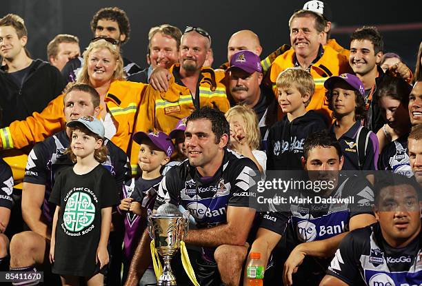 Storm players pose with Emergency Service members after winning the Emergency Services Cup defeating the Dragons in the round one NRL match between...