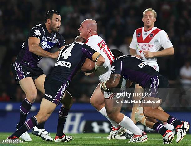 Michael Weyman of the Dragons is tackled during the round one NRL match between the Melbourne Storm and the St George Illawarra Dragons at Olympic...