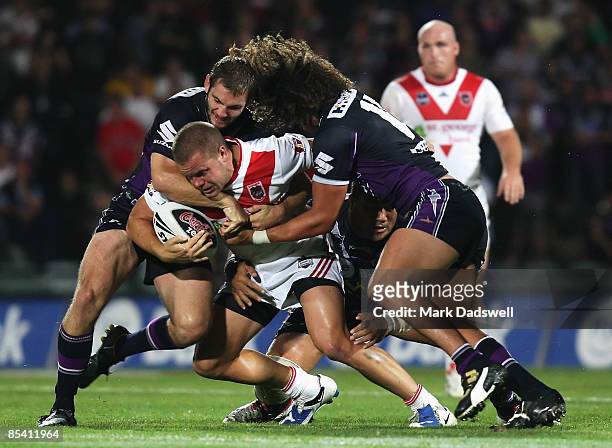 Dan Hunt of the Dragons is tackled during the round one NRL match between the Melbourne Storm and the St George Illawarra Dragons at Olympic Park on...
