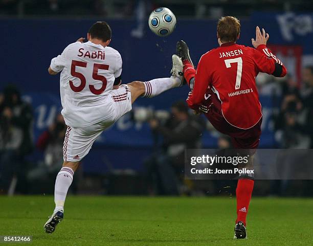 Marcell Jansen of Hamburg and Sabri Sarioglu of Galatasaray battle for the ball during the UEFA Cup Round of 16 first leg match between Hamburger SV...