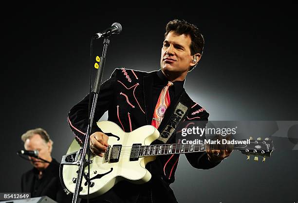 Chris Isaak performs at the half time break of the round one NRL match between the Melbourne Storm and the St George Illawarra Dragons at Olympic...