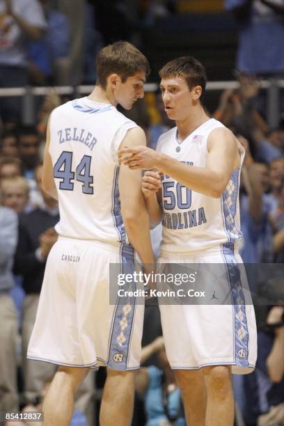 Tyler Zeller listens to Tyler Hansbrough of the North Carolina Tar Heels against the North Carolina State Wolfpack during the game on February 18,...