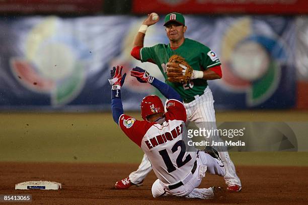 Mexican baseball player Oscar Robles and Michel Enriquez of Cuba during the World Baseball Classic 2009 on March 12, 2009 in Mexico City, Mexico.