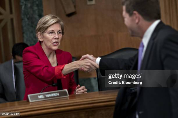 Senator Elizabeth Warren, a Democrat from Massachusetts, shakes hands with Jay Clayton, chairman of the U.S. Securities and Exchange Commission ,...