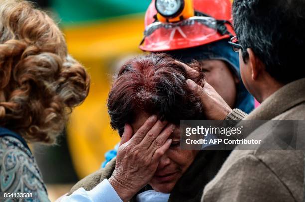 Relative of a person buried under a building toppled by a magnitude 7.1 quake that struck central Mexico a week ago, waits for news in Mexico City on...