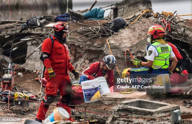 Rescuers still search for victims in a building toppled by a magnitude 7.1 quake that struck central Mexico a week ago, in Mexico City on September...