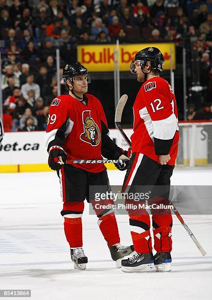 Mike Comrie and Mike Fisher of the Ottawa Senators meet on the ice during the game against the San Jose Sharks on February 26, 2009 at the Scotiabank...