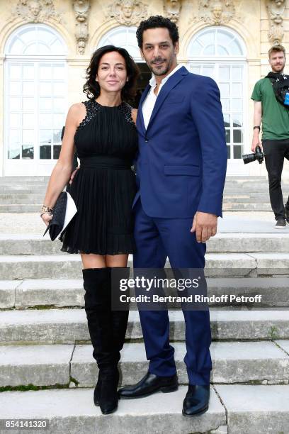 Tomer Sisley and Sandra Zeitoun attend the Christian Dior show as part of the Paris Fashion Week Womenswear Spring/Summer 2018 on September 26, 2017...