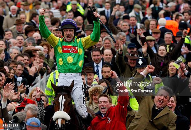 Kauto Star ridden by Ruby Walsh celebrates with trainer Paul Nicholls after winning the totesport Cheltenham Gold Cup during day 4 of the Cheltenham...