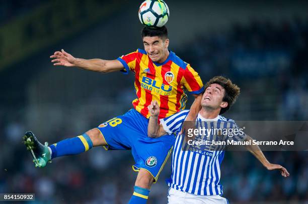Carlos Soler of Valencia CF duels for the ball with Alvaro Odriozola of Real Sociedad during the La Liga match between Real Sociedad de Futbol and...