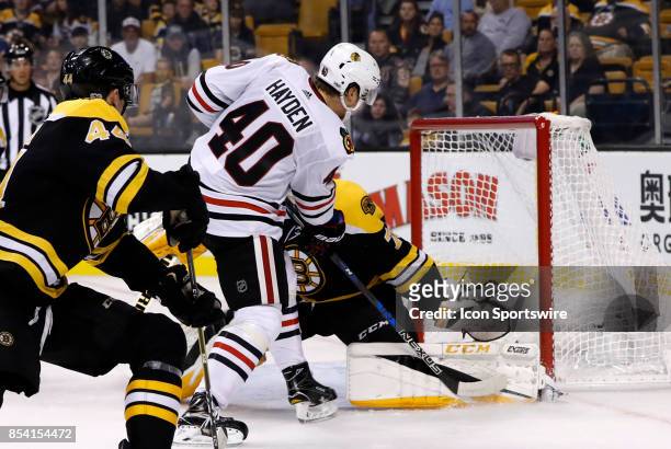 Boston Bruins goalie Malcolm Subban makes a left pad save on Chicago Blackhawks left wing John Hayden during a preseason game between the Boston...
