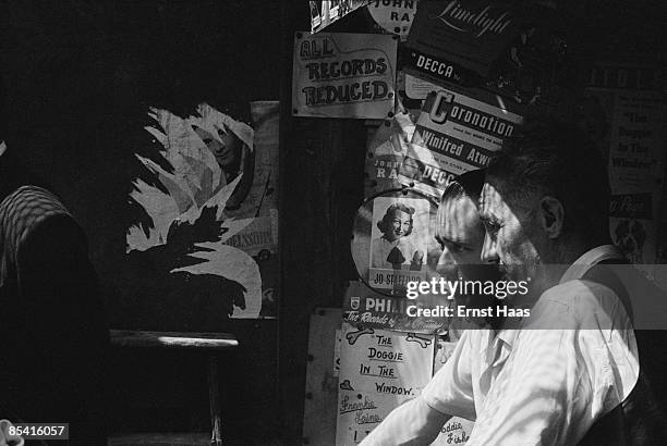 Torn posters advertising songs by Jo Stafford and Frankie Laine in Petticoat Lane Market, London, 1953.