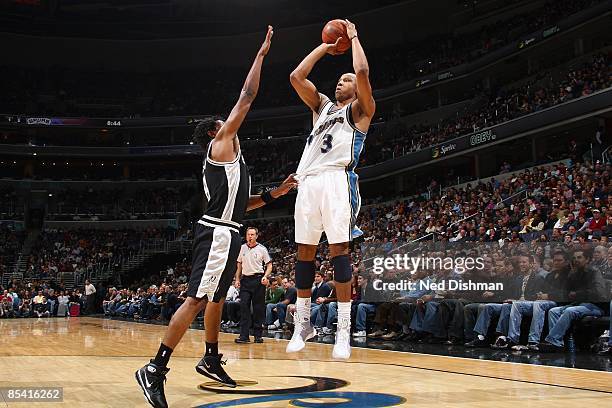 Caron Butler of the Washington Wizards takes a jump shot against Roger Mason of the San Antonio Spurs during the game at the Verizon Center on...