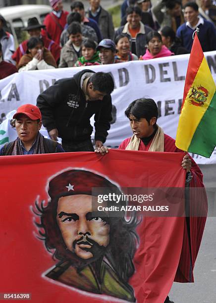 Aymara indigenous hold a banner with a portrait of revolutionary leader Ernesto Che Guevara during a rally from El Alto to La Paz in celebration of...