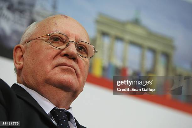 Former Soviet President Mikhail Gorbachev sits in front of a photograph of the Brandenburg Gate while attending the Urania Medal award at the Urania...