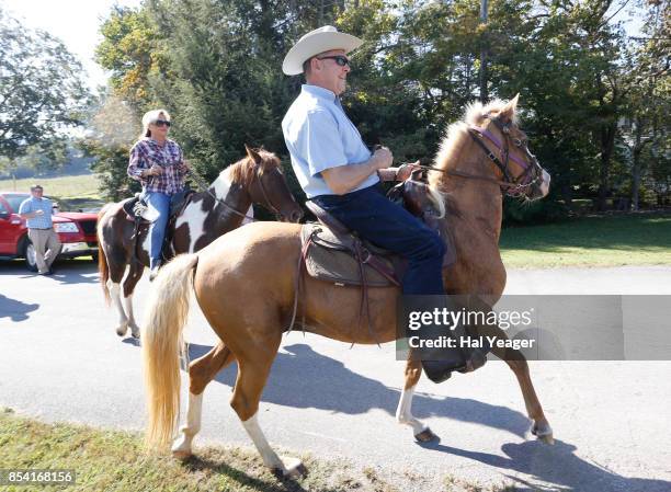 Alabama Republican U.S. Senate candidate Roy Moore on Sassy and wife Kayla on Sundance ride their horses to the Gallant Fire Hall to vote in today's...