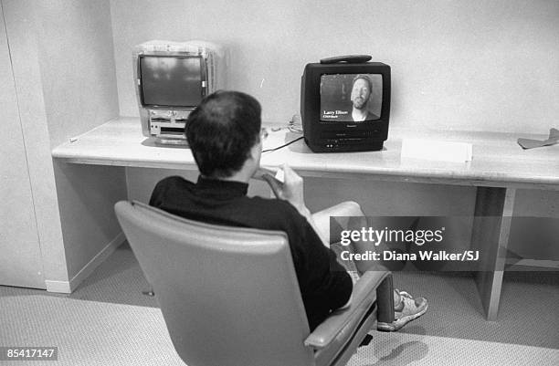 Apple CEO Steve Jobs reviewing tape of Oracle boss Larry Ellison promoting Apple's new board in Apple HQ boardroom day before heading to Boston for...