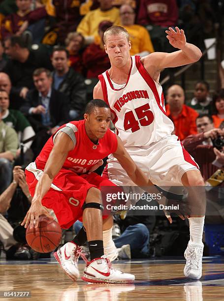 Evan Turner of the Ohio State Buckeyes drives against Joe Krabbenhoft of the Wisconsin Badgers during the second round of the Big Ten Men's...