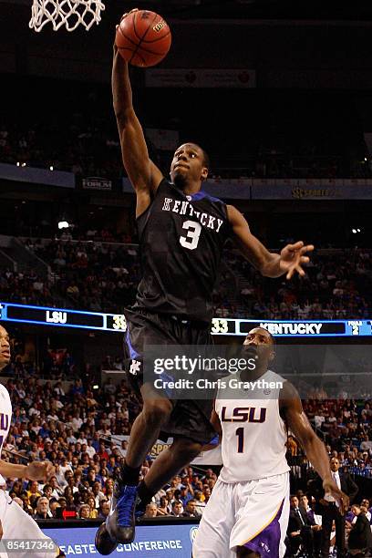 Kevin Galloway of the Kentucky Wildcats dunks the ball over Tasmin Mitchell of the Louisiana State University Tigers during the second round of the...