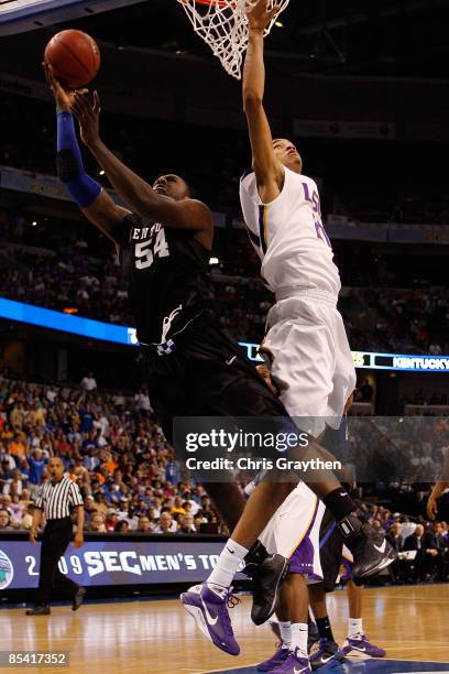 Patrick Patterson of the Kentucky Wildcats makes a shot over Chris Johnson of the Louisiana State University Tigers during the second round of the...