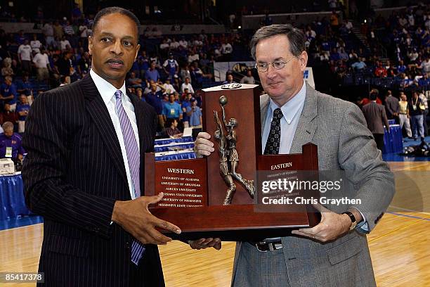 Head coach Trent Johnson of the Louisiana State University Tigers poses for a photo with the regular season SEC trophy before the game against the...