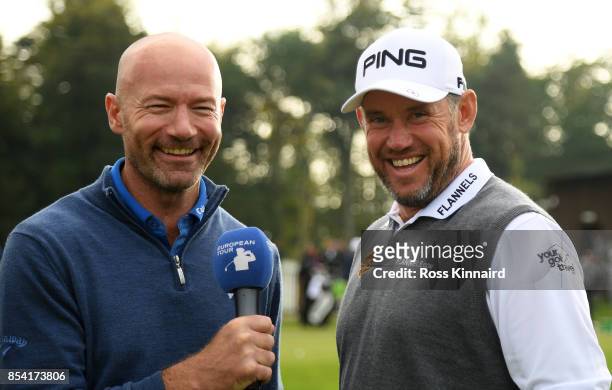 Lee Westwood of England is interviewed by former international footballer Alan Shearer during a practice round prior to the British Masters at Close...