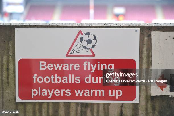 General view of a sign that reads 'Beware flying footballs during players warm up'
