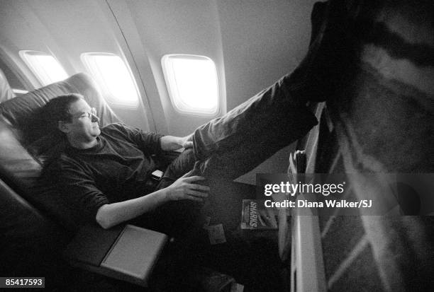 Steve Jobs, Apple CEO, stretches out during his flight from California to the Macworld Expo in Boston, MA on August 5, 1997.