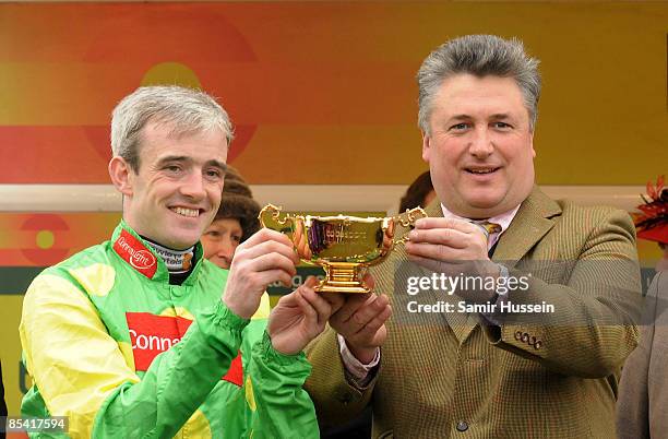 Winning jockey Ruby Walsh and Paul Nicholls, trainer of Gold Cup winning horse Kauto Star, hold the Gold Cup on Gold Cup day at the Cheltenham...