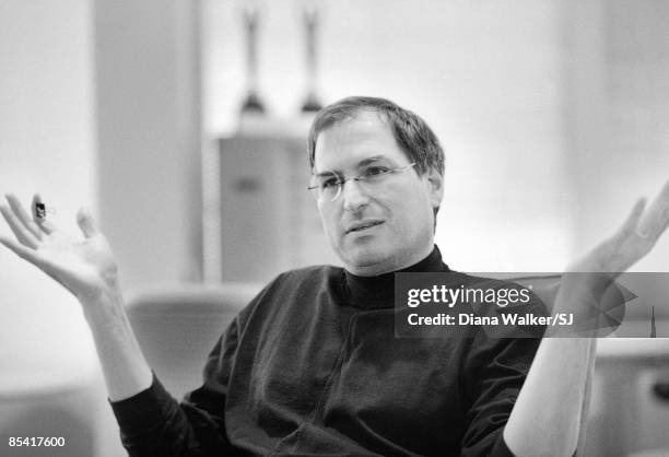 Apple Computer head Steve Jobs deep in thought, propping sneakered feet on conference table in boardroom at Apple HQ day before heading to Boston for...