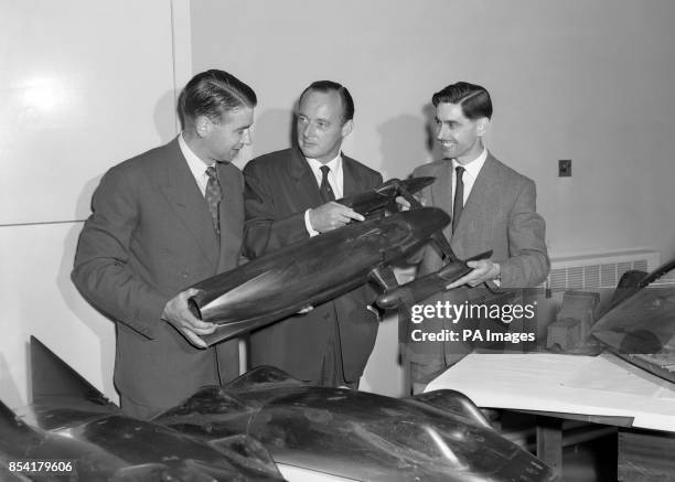 Donald Campbell and chief designers Lewis Norris and Kenneth Norris examine a model of the modified Bluebird to be used by Mr Campbell next month in...