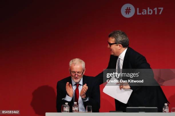 Deputy Labour party leader Tom Watson gets up to make a speech to delegates in the main hall as Labour party leader Jeremy Corbyn applauds, on day...