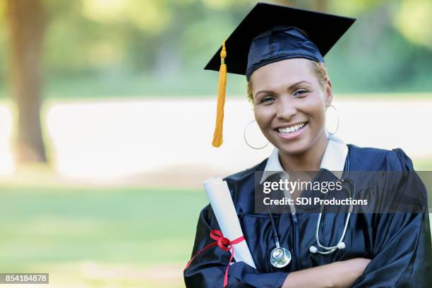 mid adult african american woman graduates from medical school - medical school graduation stock pictures, royalty-free photos & images